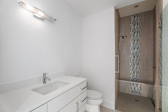 bathroom with vanity, toilet, and a shower with shower door