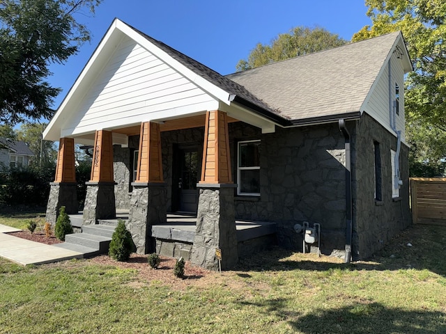 view of front of property with a porch and a front yard