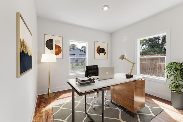 office area featuring wood-type flooring and a healthy amount of sunlight