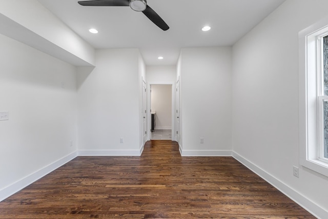 empty room with dark hardwood / wood-style flooring and ceiling fan