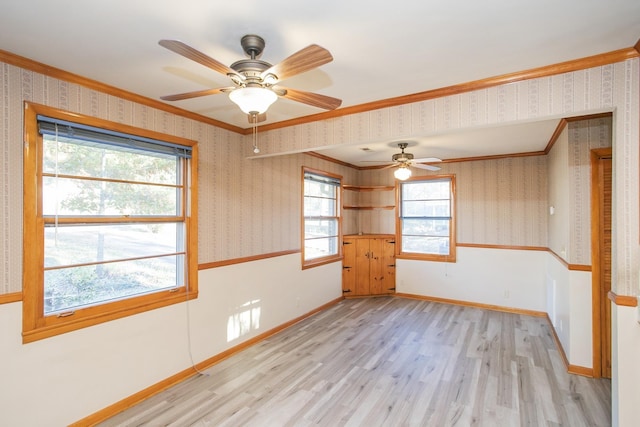 unfurnished room with ceiling fan, a healthy amount of sunlight, and light wood-type flooring