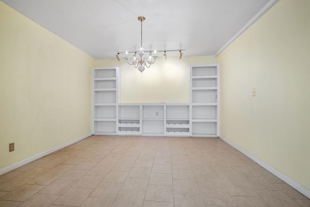 empty room featuring a notable chandelier