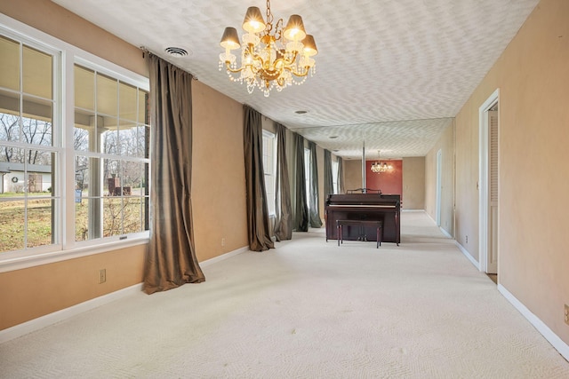 miscellaneous room with a notable chandelier and light carpet