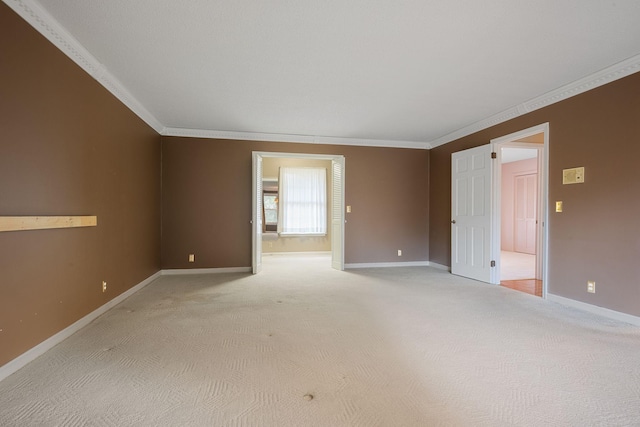 carpeted spare room with ornamental molding