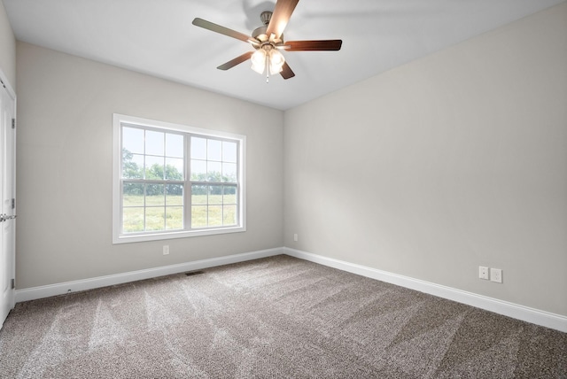 unfurnished room featuring ceiling fan and carpet