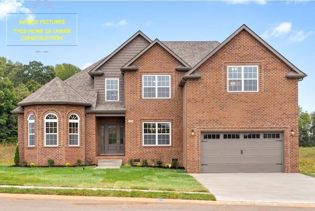 view of front of house featuring a front lawn and a garage