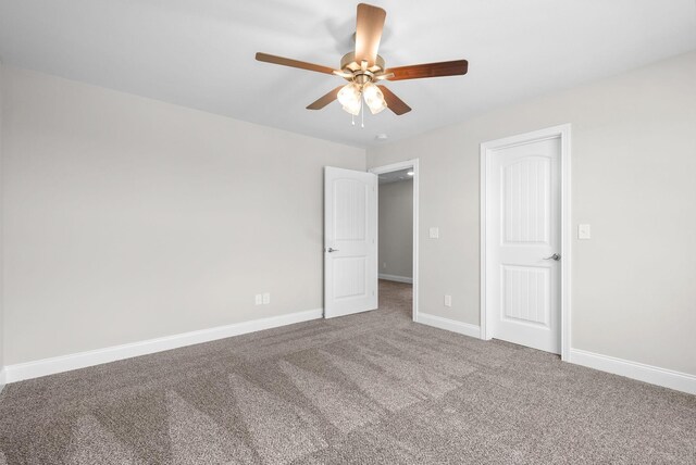 spare room featuring ceiling fan and carpet flooring