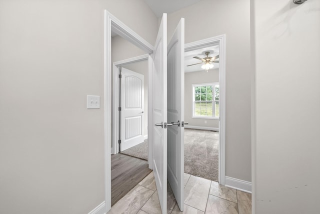 hallway featuring light tile patterned flooring