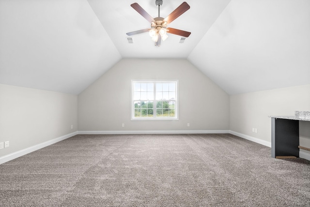 additional living space featuring vaulted ceiling, ceiling fan, and carpet flooring