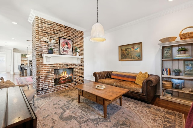 living room with hardwood / wood-style flooring, a fireplace, and ornamental molding