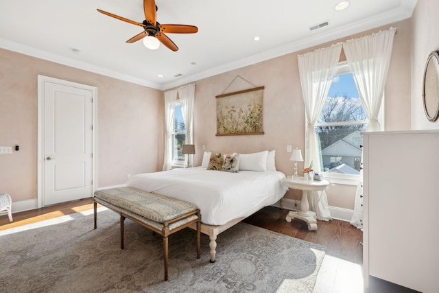 bedroom featuring hardwood / wood-style flooring, ceiling fan, and ornamental molding