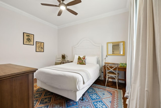 bedroom featuring dark hardwood / wood-style floors, ceiling fan, and ornamental molding