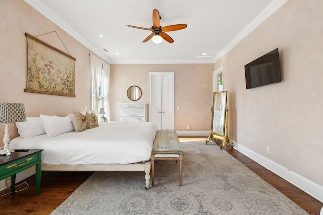 bedroom with ceiling fan, ornamental molding, and dark wood-type flooring