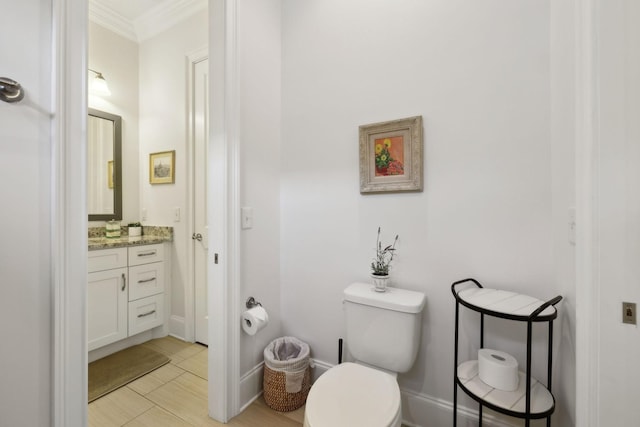 bathroom with vanity, toilet, and crown molding