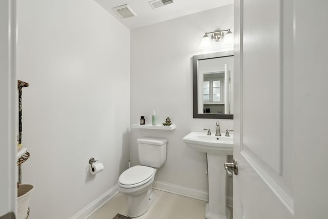 bathroom featuring tile patterned floors, toilet, and sink