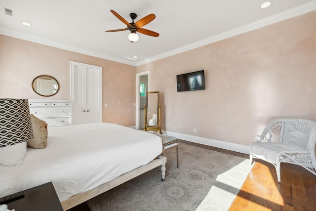 bedroom with hardwood / wood-style flooring, ceiling fan, and ornamental molding