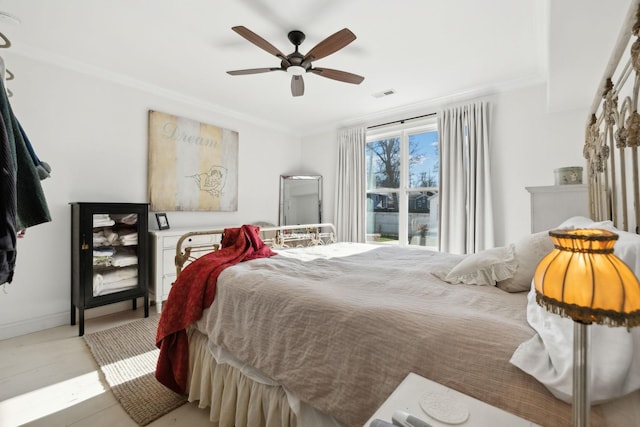 bedroom featuring ceiling fan and ornamental molding