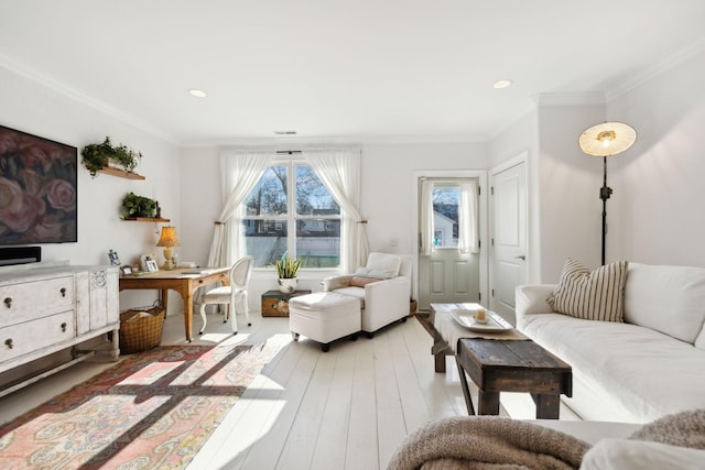 living room with crown molding and light hardwood / wood-style floors