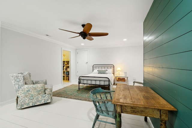 bedroom with ceiling fan, a spacious closet, and crown molding