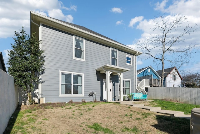 rear view of house with a yard