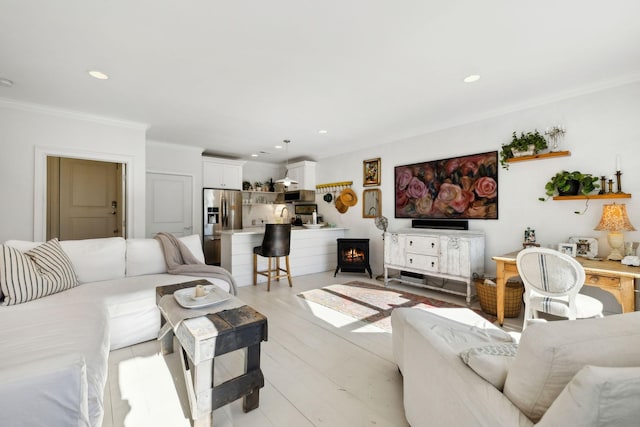 living room with crown molding and light hardwood / wood-style flooring