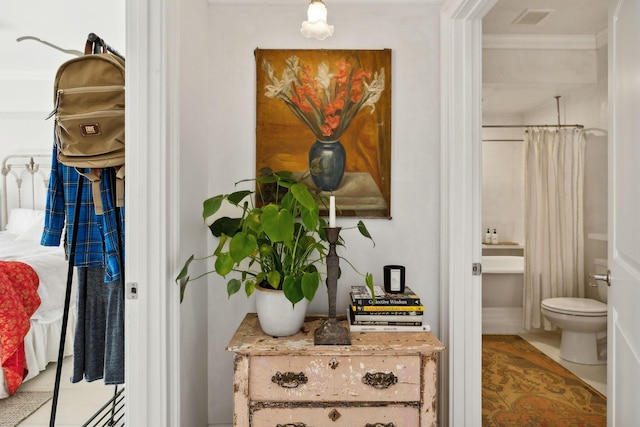 bathroom featuring toilet and ornamental molding