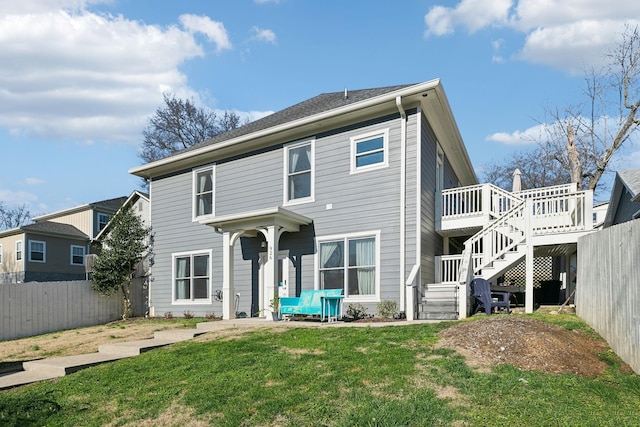 view of front of house with a front yard and a deck