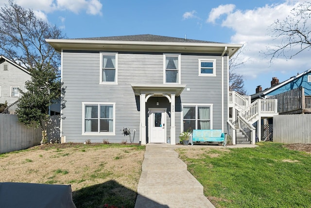 view of front of home with a wooden deck and a front yard