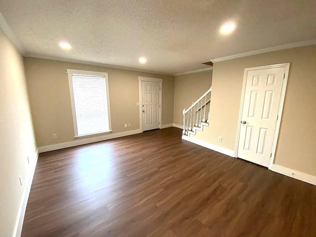 unfurnished room with crown molding, dark hardwood / wood-style floors, and a textured ceiling