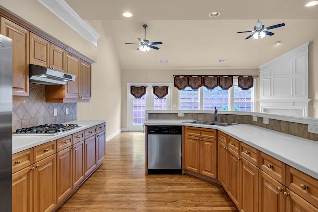 kitchen featuring a wealth of natural light, stainless steel appliances, tasteful backsplash, and sink