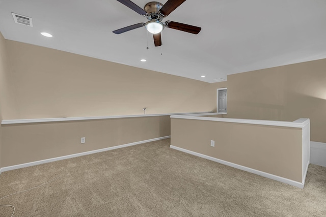 carpeted spare room with ceiling fan