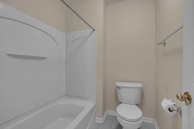 bathroom featuring tile patterned floors, toilet, and shower / washtub combination