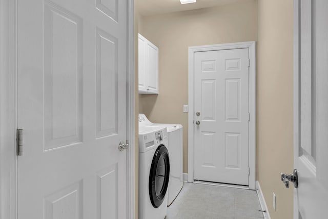 laundry area with cabinets and washing machine and dryer