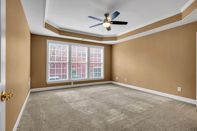 unfurnished room with carpet floors, a raised ceiling, ceiling fan, and ornamental molding