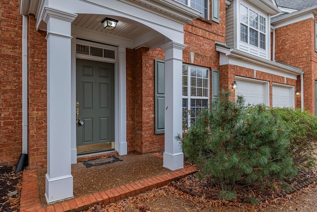 view of exterior entry with a garage