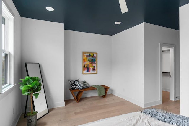 bedroom featuring a skylight and light hardwood / wood-style flooring