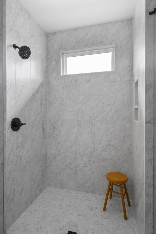 bathroom with tiled shower