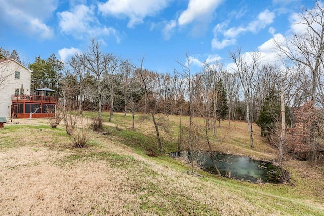 view of yard with a deck with water view