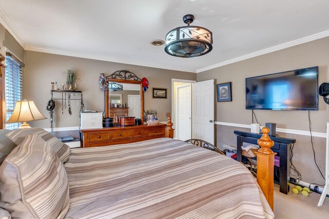 carpeted bedroom with ornamental molding