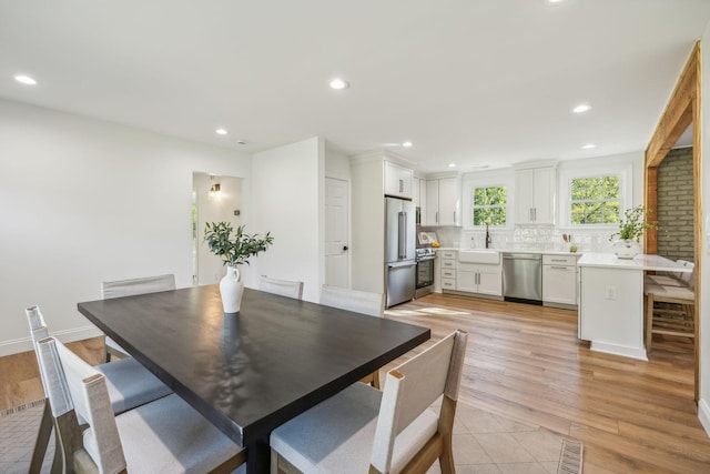 dining space featuring sink and light hardwood / wood-style floors