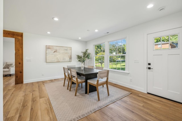 dining area with light hardwood / wood-style floors and a wealth of natural light