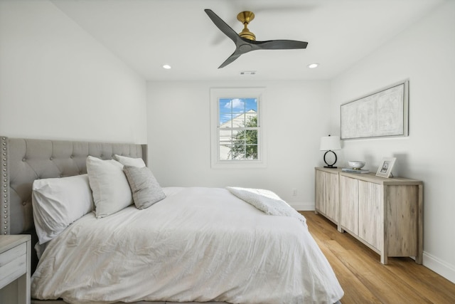 bedroom with ceiling fan and light hardwood / wood-style floors