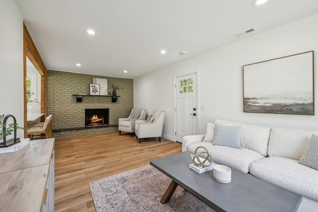 living room featuring a fireplace and light hardwood / wood-style flooring