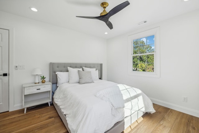 bedroom featuring dark hardwood / wood-style flooring and ceiling fan