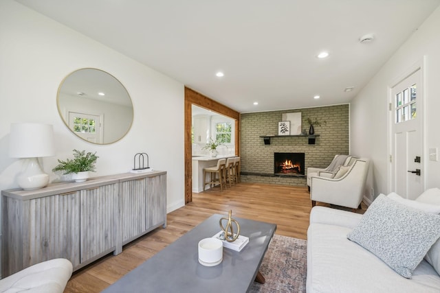 living room with light hardwood / wood-style floors and a fireplace