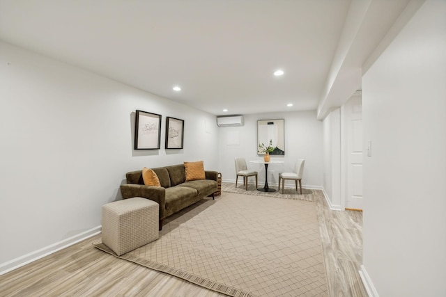 living room featuring light hardwood / wood-style floors and a wall mounted AC