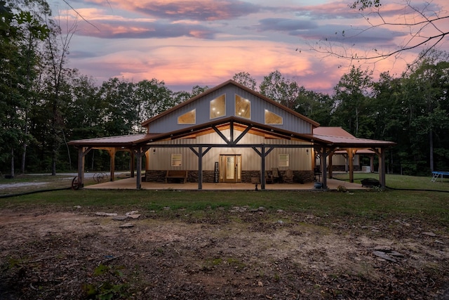 back house at dusk with a patio area and a trampoline