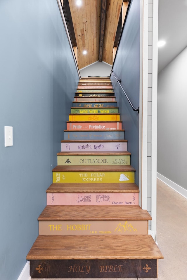 stairs featuring wooden ceiling and vaulted ceiling