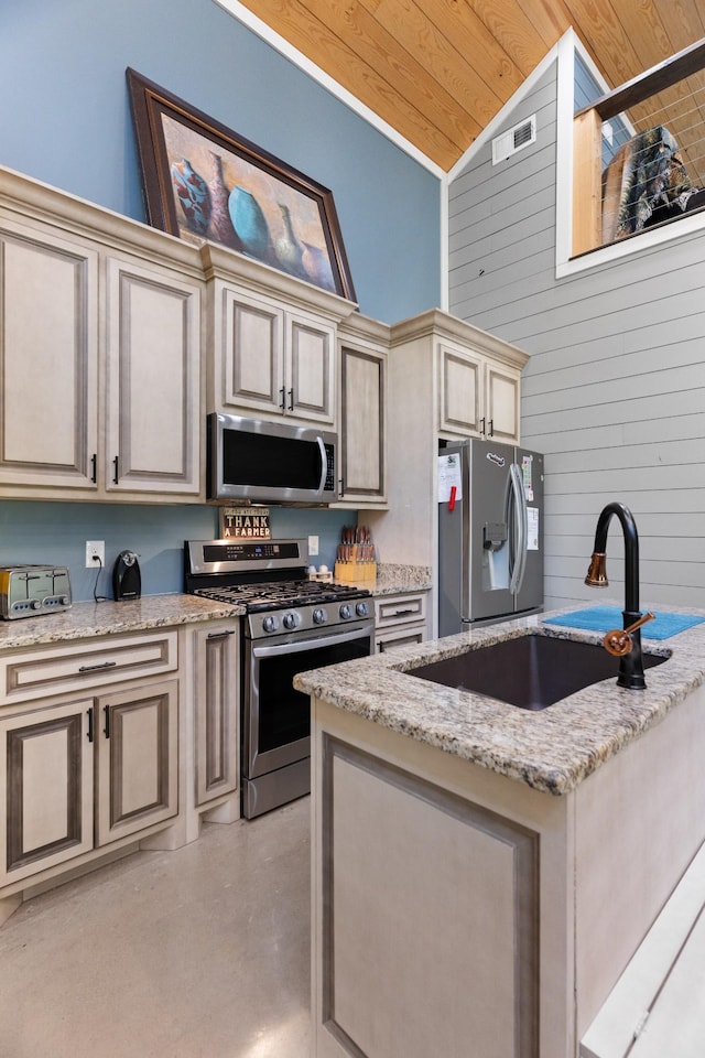 kitchen featuring light stone countertops, appliances with stainless steel finishes, sink, wooden ceiling, and cream cabinetry