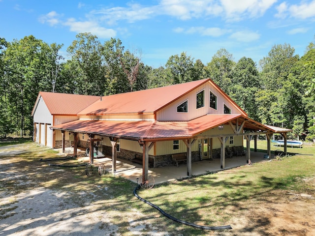 rear view of house featuring a garage and a lawn